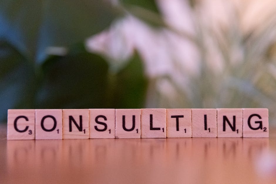 Wooden letter tiles spelling 'Consulting' with a blurred background